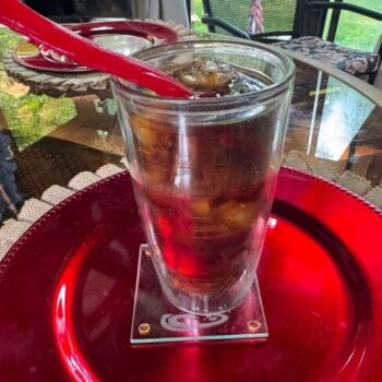 Glass full of cherry coke with licorice.