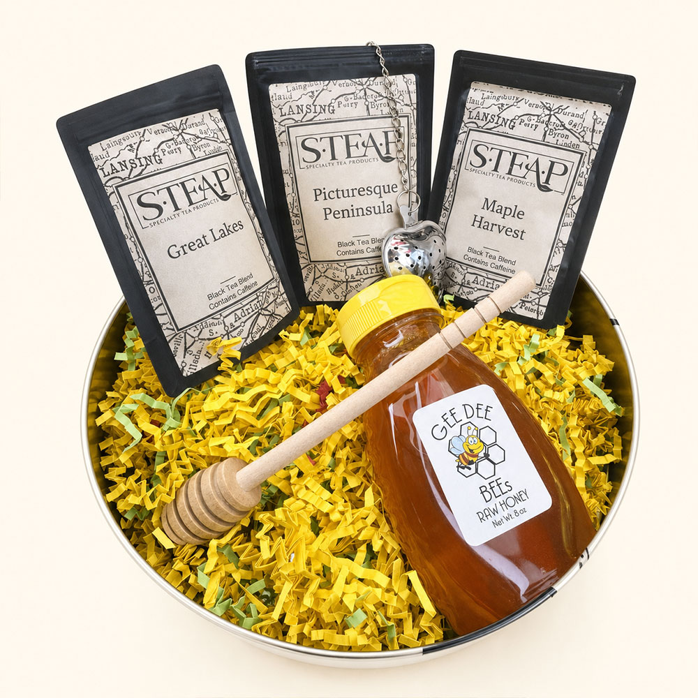 Tin filled with tea bags, honey, and a diffuser.